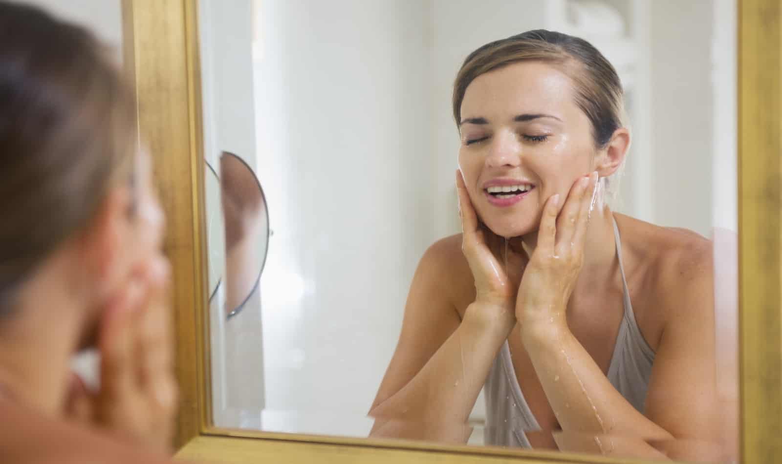 Young woman using Cerave to wash her face