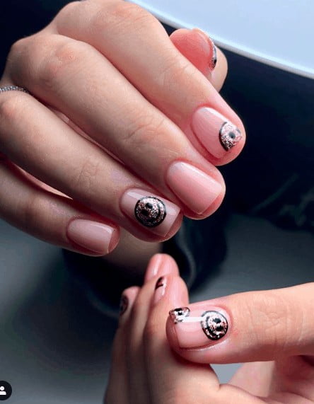 colorless nails with black and gold smiley faces