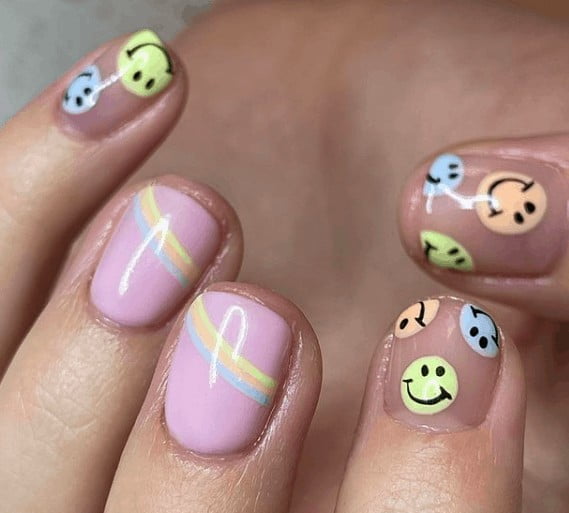 pink nails with smiling face designs