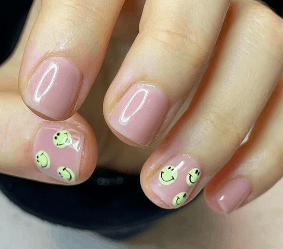 nude pink nails with smiley faces