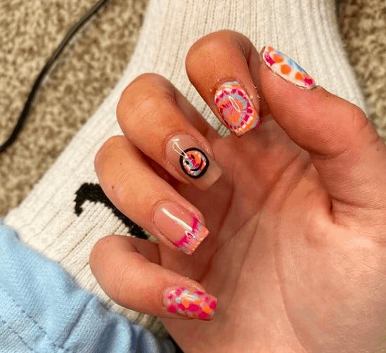 neon nail design with one smiley face in the middle finger