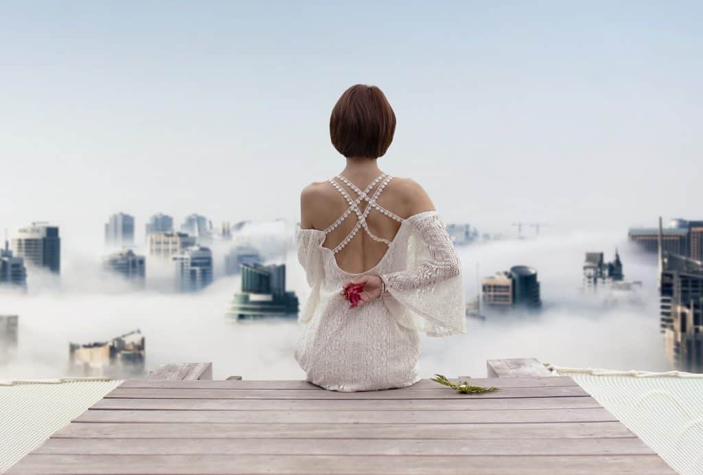 a short hair lady in white backless dress