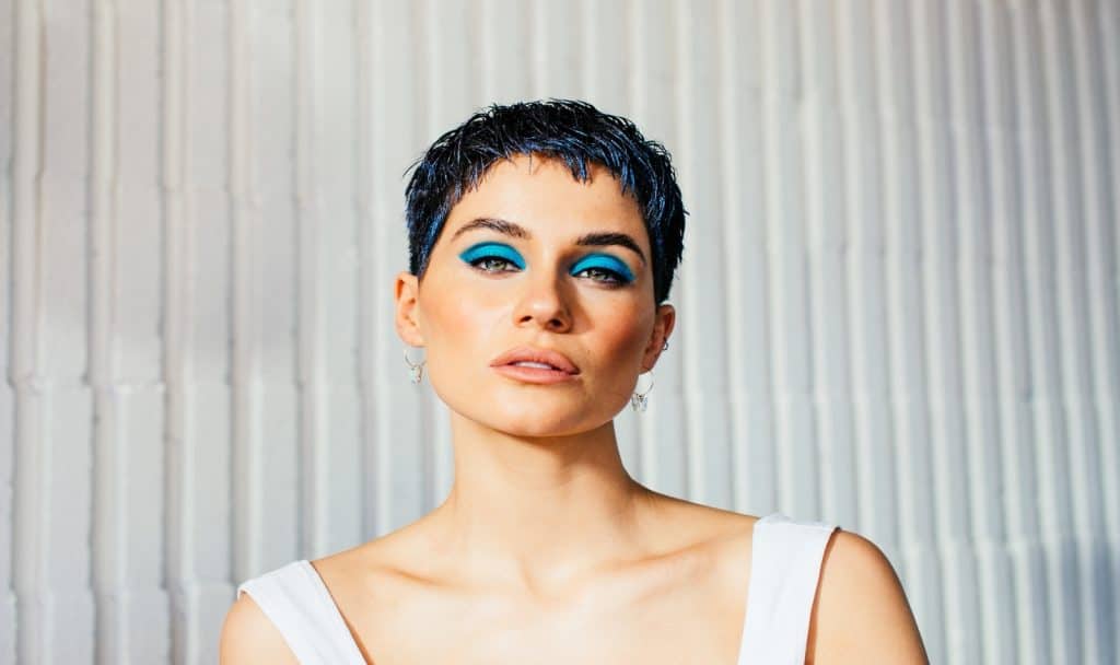 a gorgeous short hair lady with bright blue eyeshadows