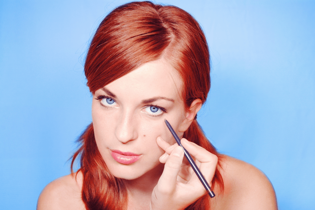 a red-haired lady wearing a white eyeliner