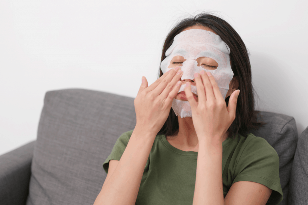a lady using a face mask for her overnight regimen