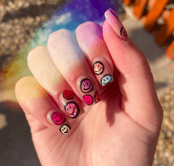 colorful smiley faces nail designs with black outlines