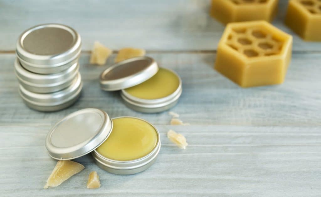 homemade natural lip balm on wooden table background.