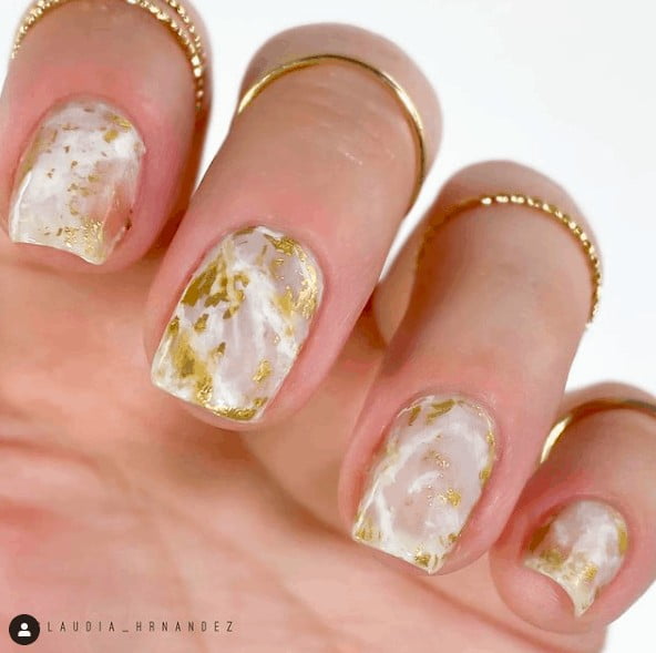 nails with white and gold marble designs
