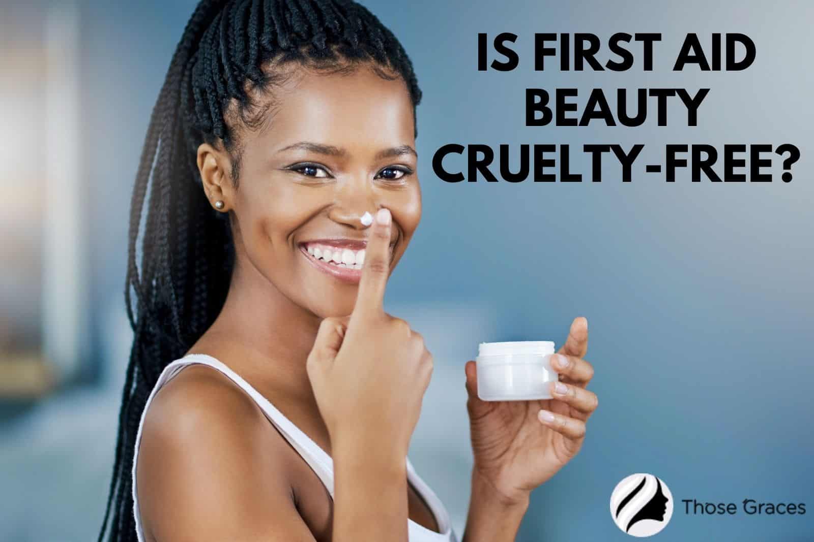 a beautiful lady holding a cream with the question "Is First Aid Beauty cruelty free?"