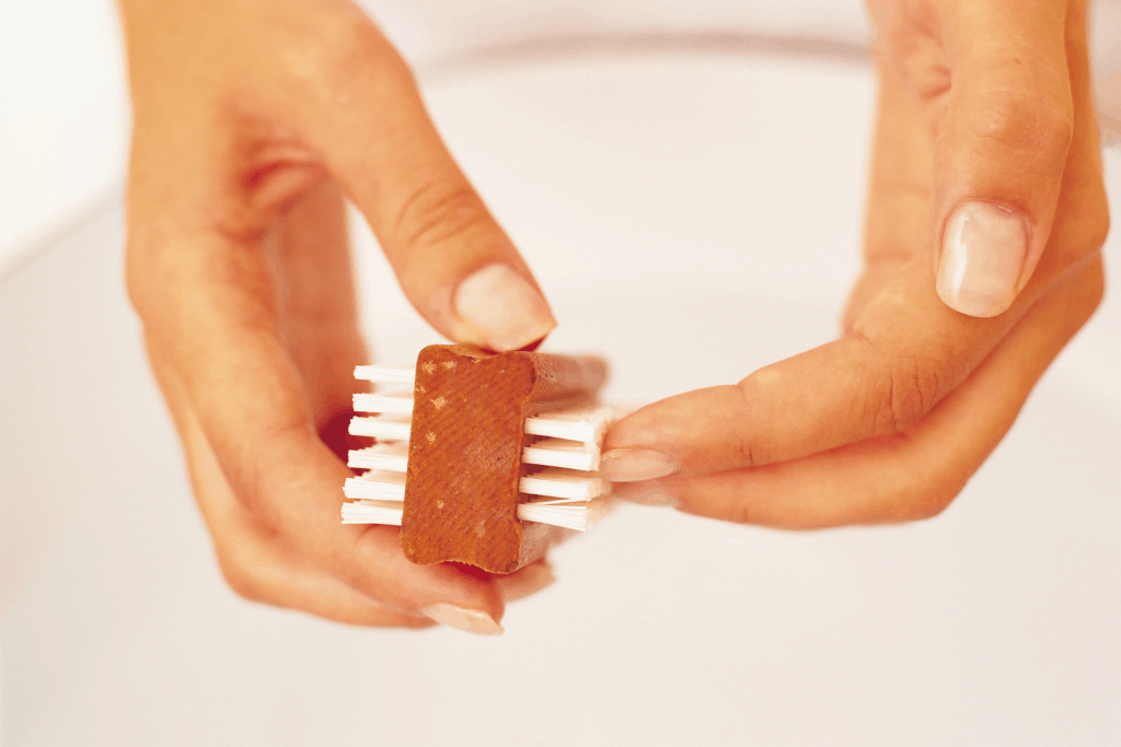 cleaning the nails with a brush