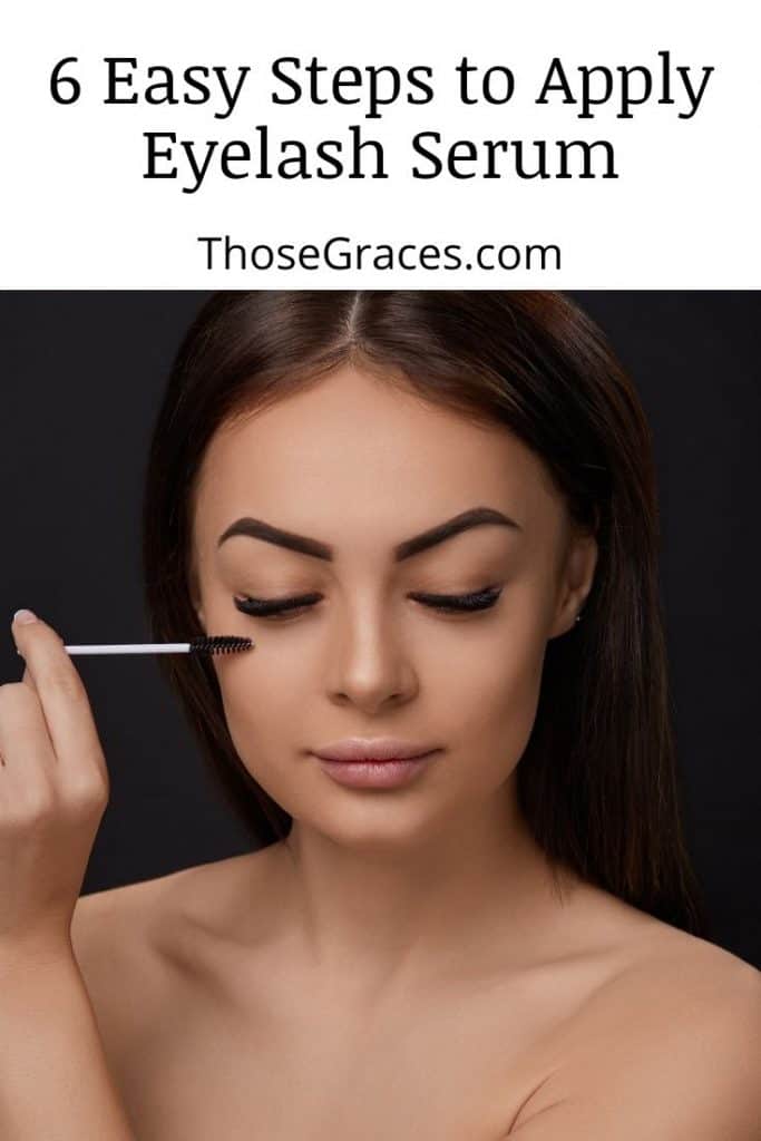 a beautiful woman applying an eyelash serum to her lashes