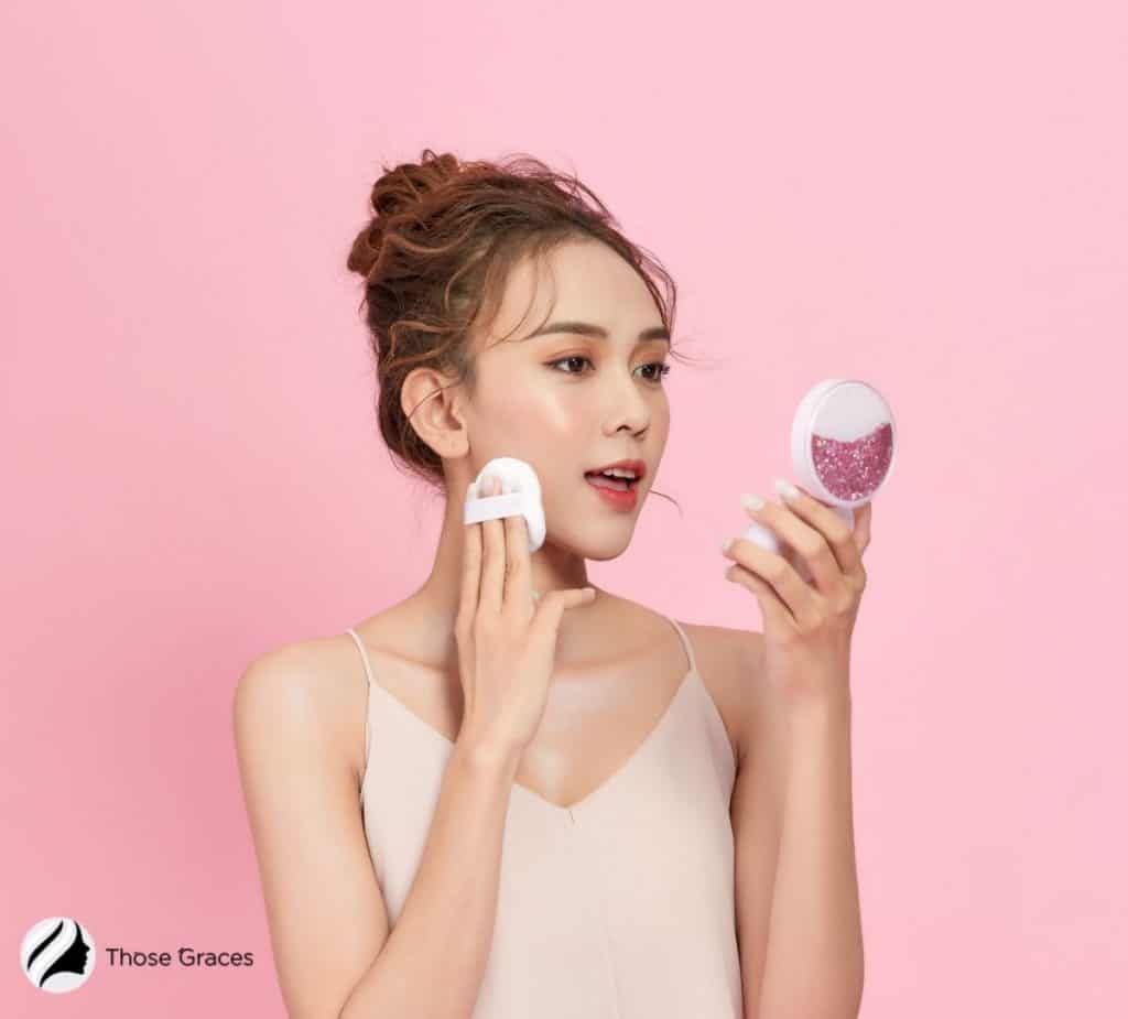 Korean girl putting cushion foundation on her right cheek