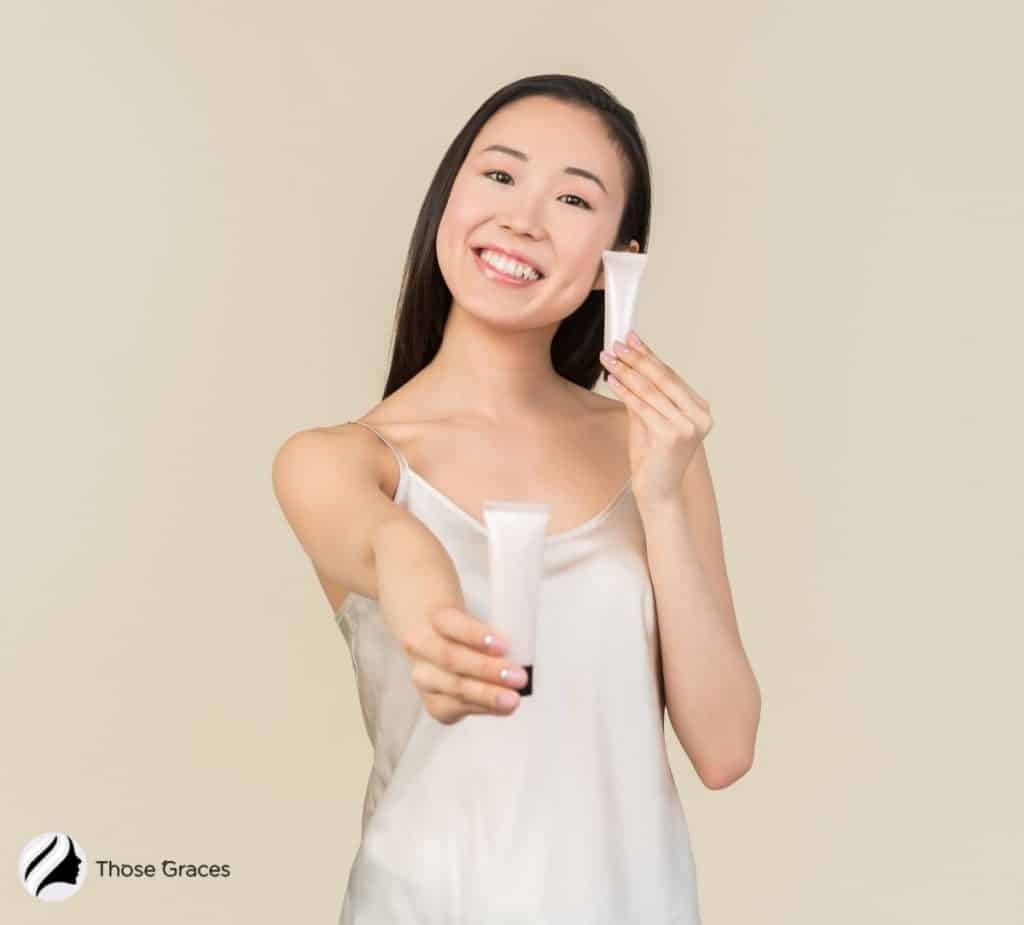 Asian lady holding two Korean BB creams