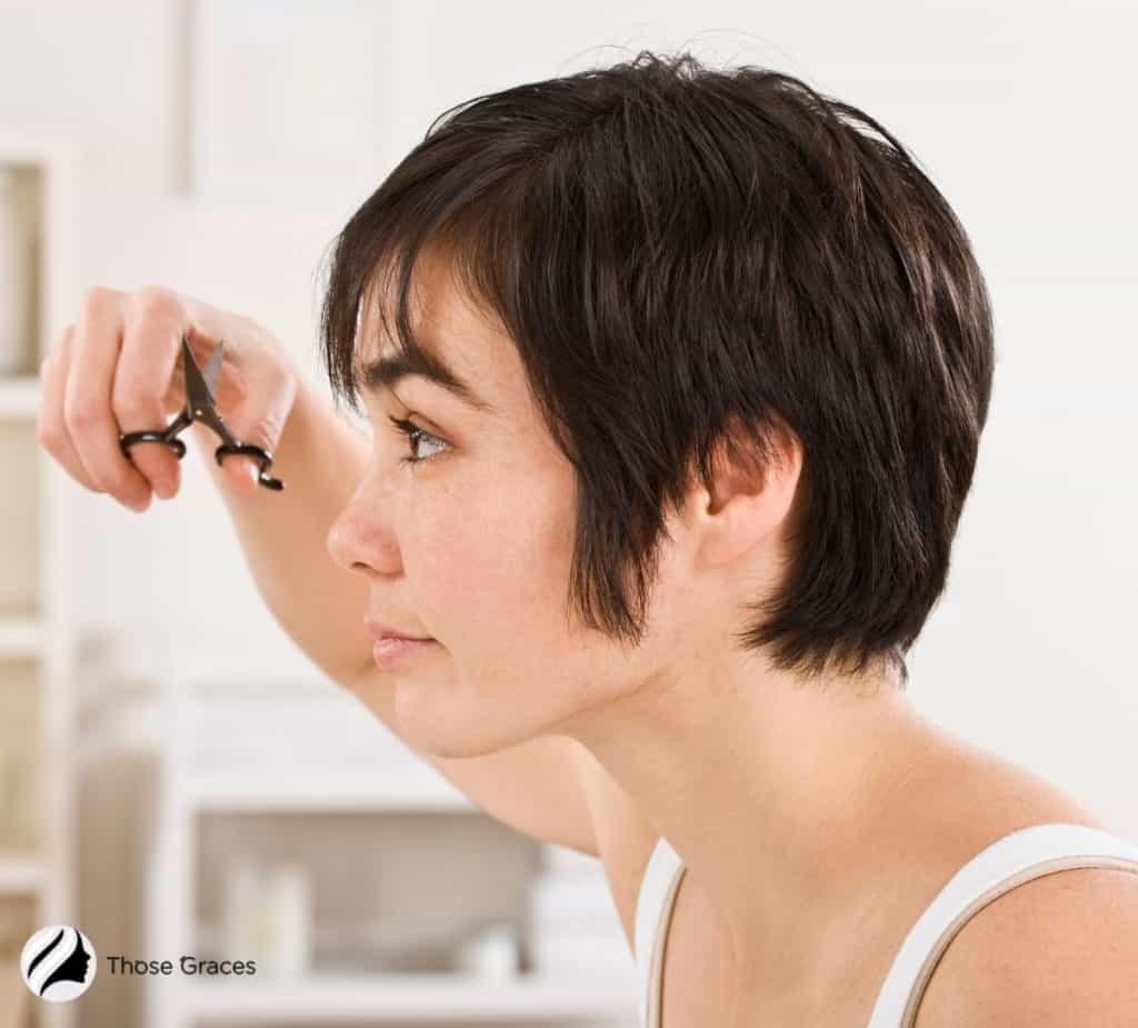 lady cutting her baby hair to get the perfect Korean bangs
