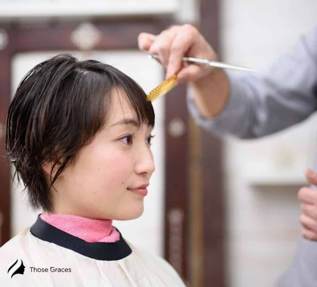 a Korean lady getting her Korean bangs done in a salon