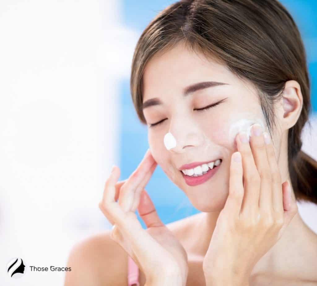 an Asian girl cleansing her face