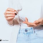 a girl putting an ampoule on her fingertips