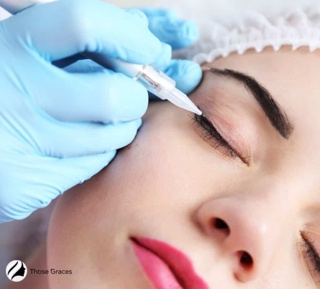 a cute lady getting a permanent tattoo eyeliner session