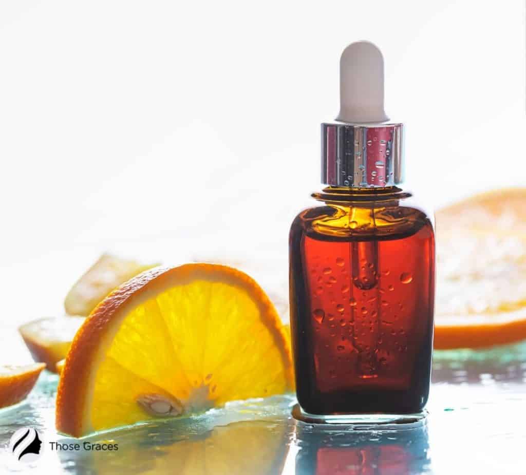 Korean vitamin C serum beside a slice of orange