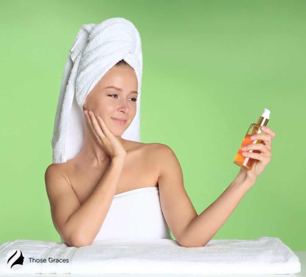 smiling lady holding an oil-based cleanser