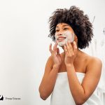 lady using cream cleanser to wash her face