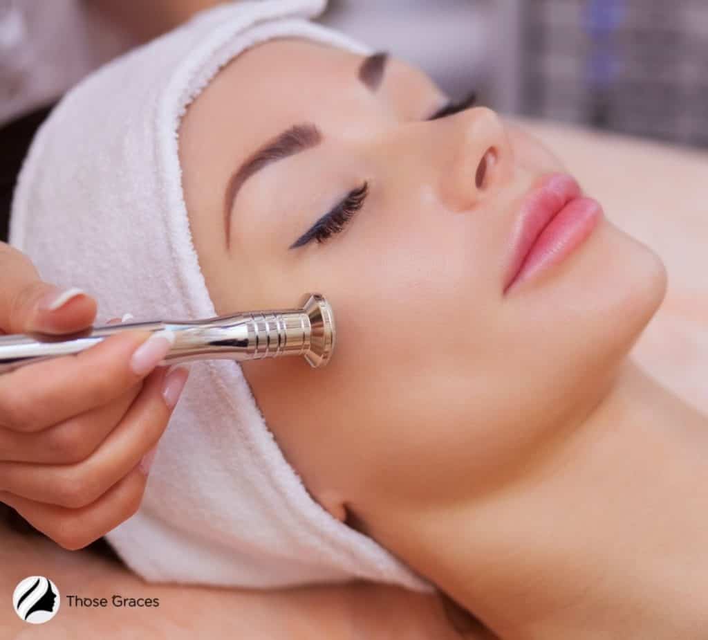 crystal microdermabrasion machine being used on the lady's face