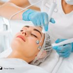 professional performing facial microcurrent to the woman