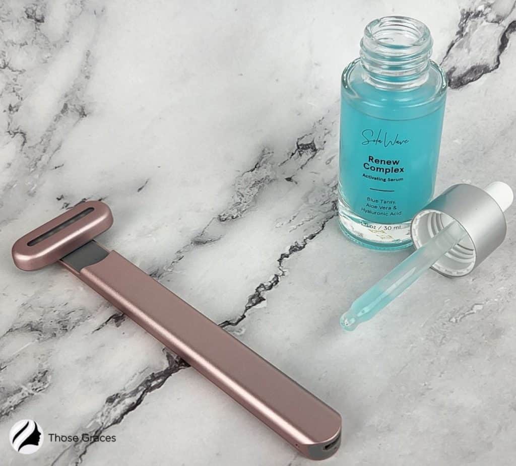 solawave facial wand and opened serum on the table