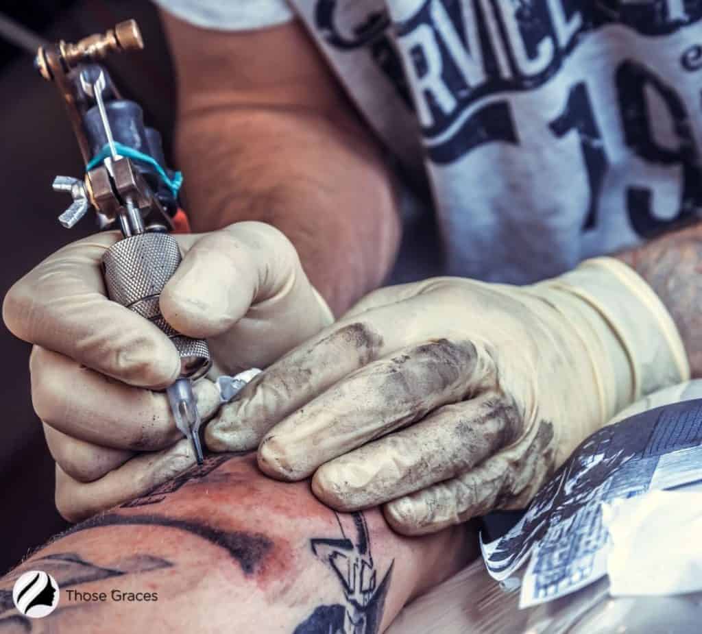 Tattoo artist using a tattoo gun