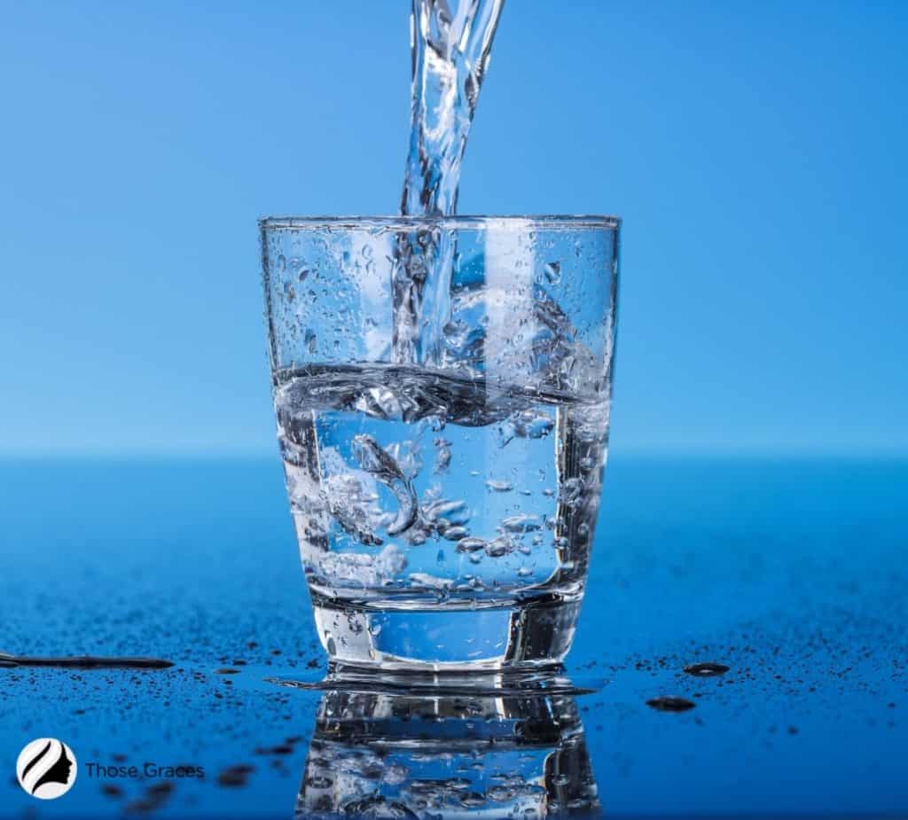 pouring water on a glass