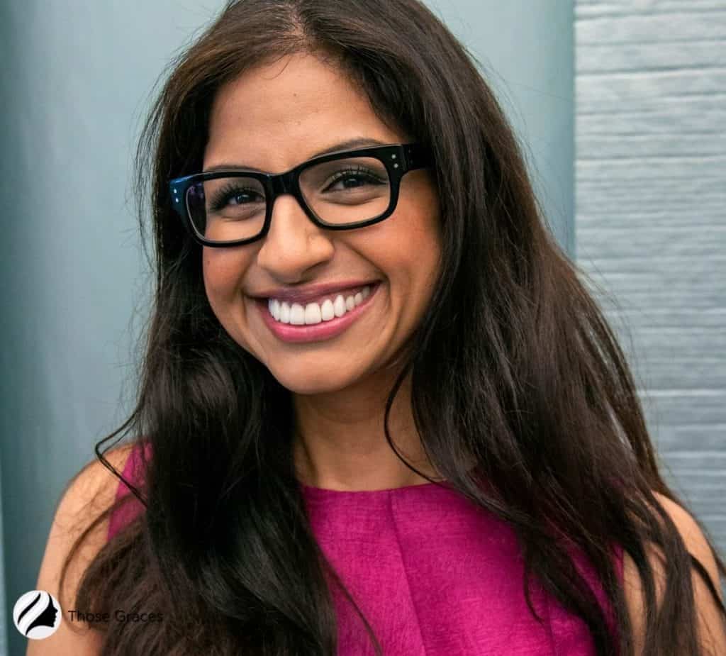 woman with an olive skin wearing a magenta colored outfit