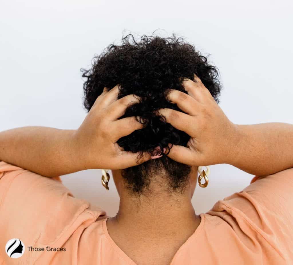 lady scratching the back of her head because of mildew in hair