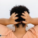 lady scratching the back of her head because of mildew in hair