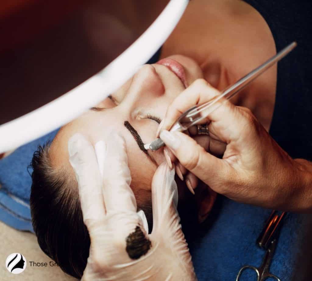 lady in a microblading session but How Much Does Microblading Cost?