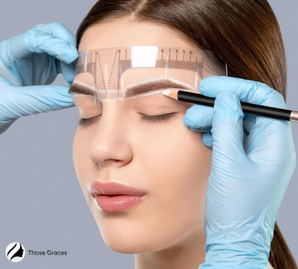 measuring the lady's eyebrow for microblading