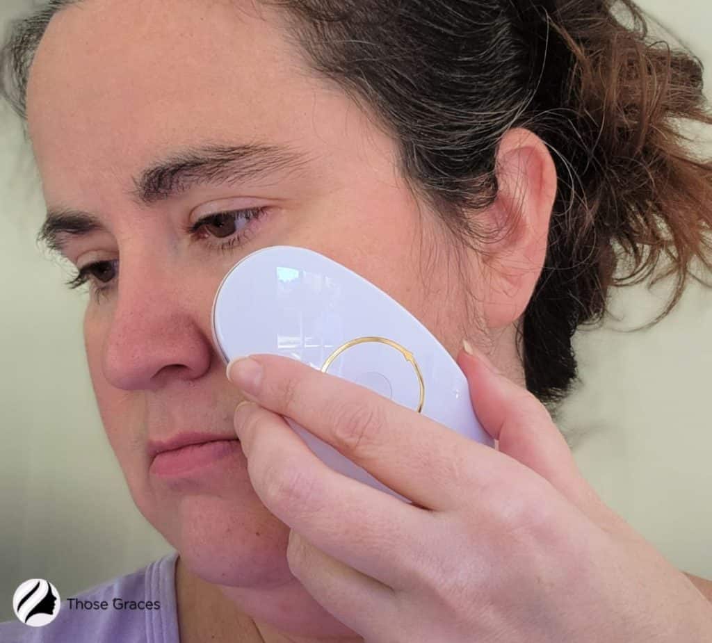 lady using a ZIIP Beauty Nano Current device for her face