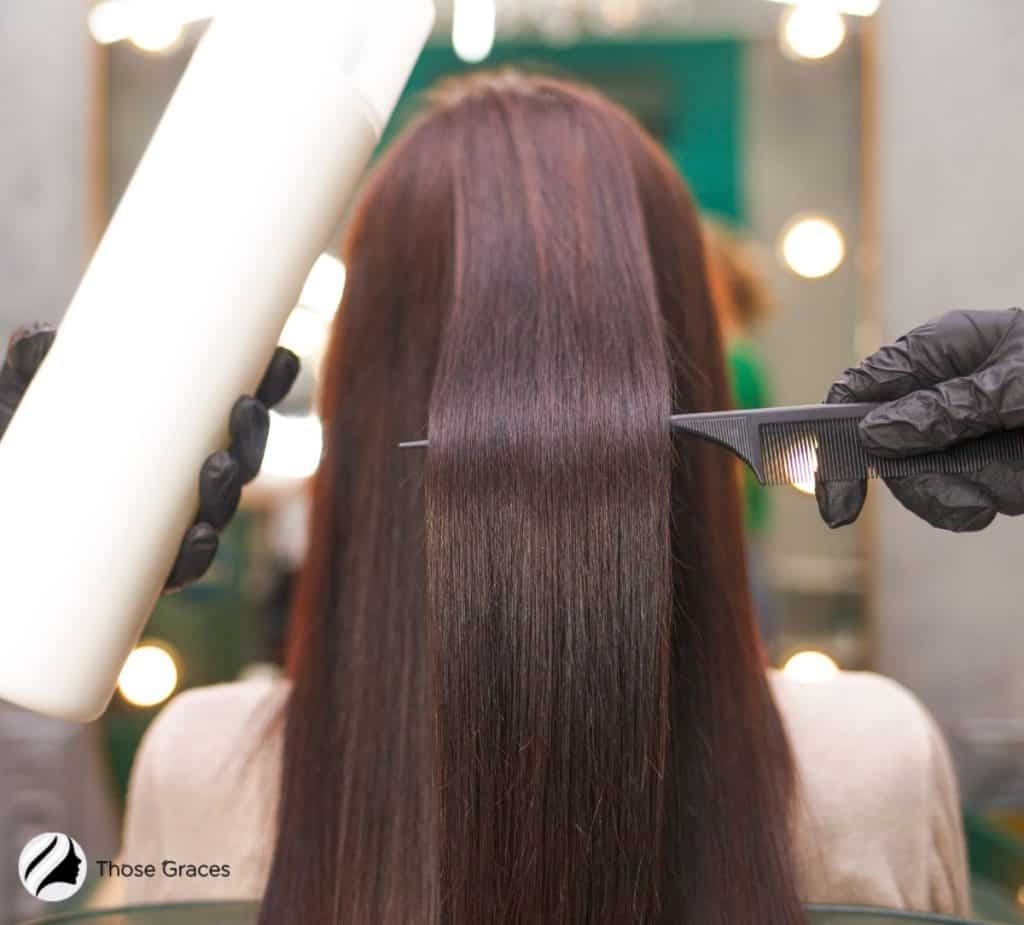 professional preparing the lady's hair for the keratin treatment