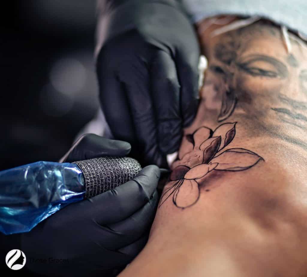 women getting tattoo touch up