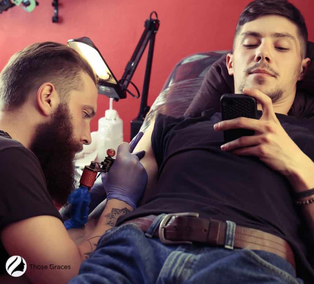 men getting tattoo on hand and wondering how to get tattoo ink out of clothes