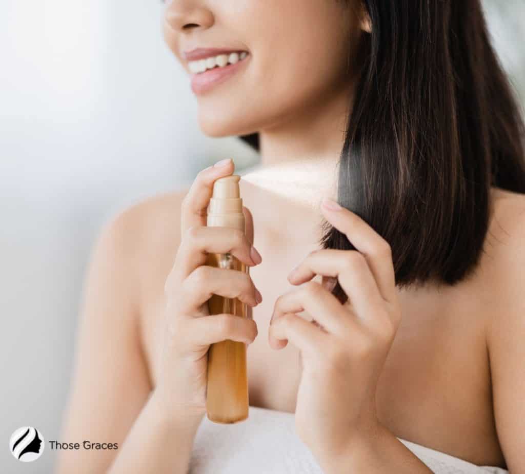 women protecting her hair from heat damage using hair spray