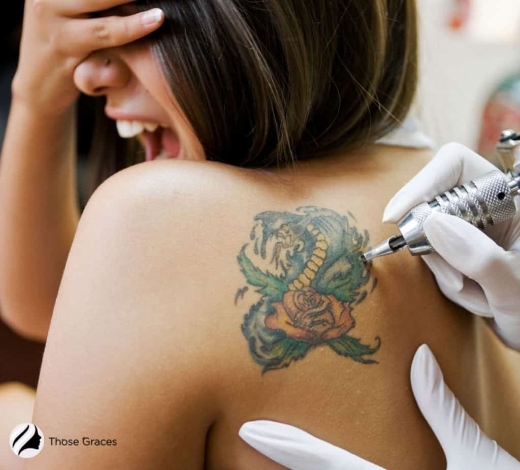 women feeling pain while getting tattoo