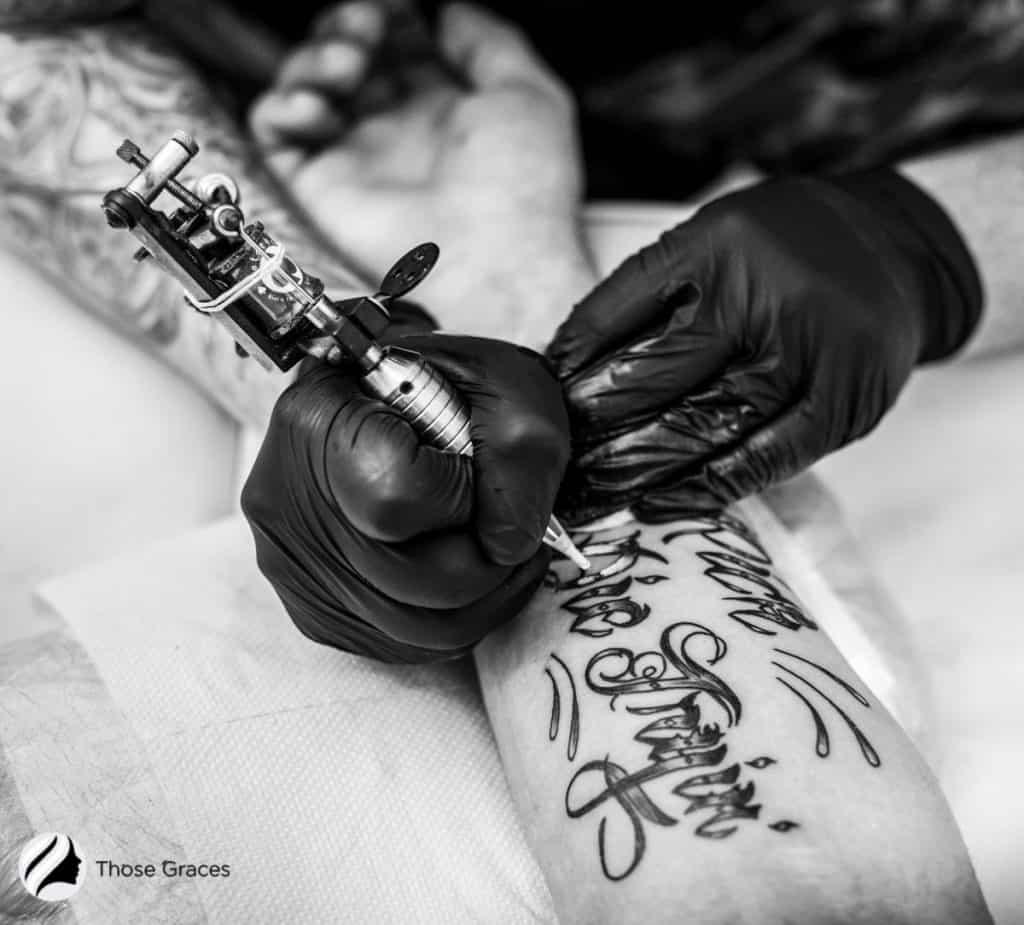 women getting tattoo on hand