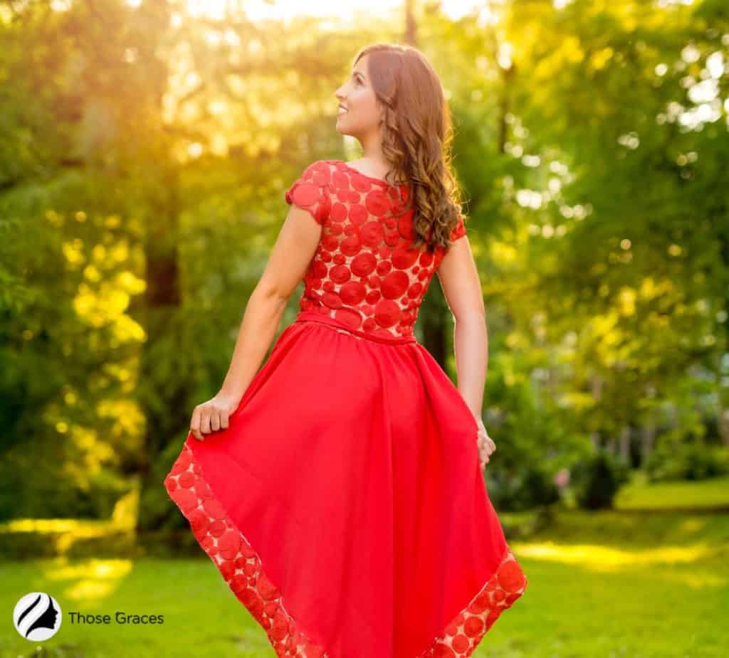 beautiful lady wearing a red dress in a park