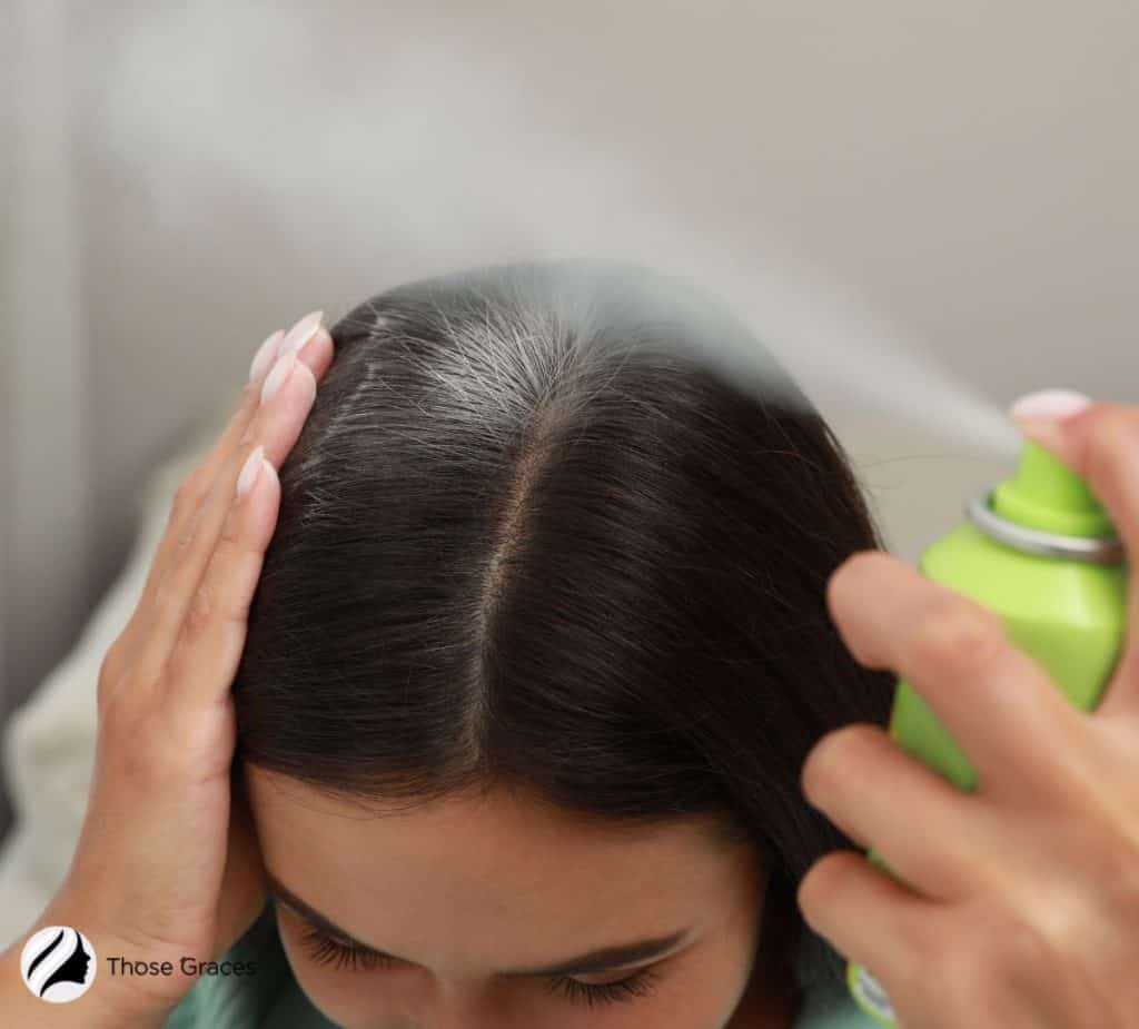 using dry shampoo on a woman's hair