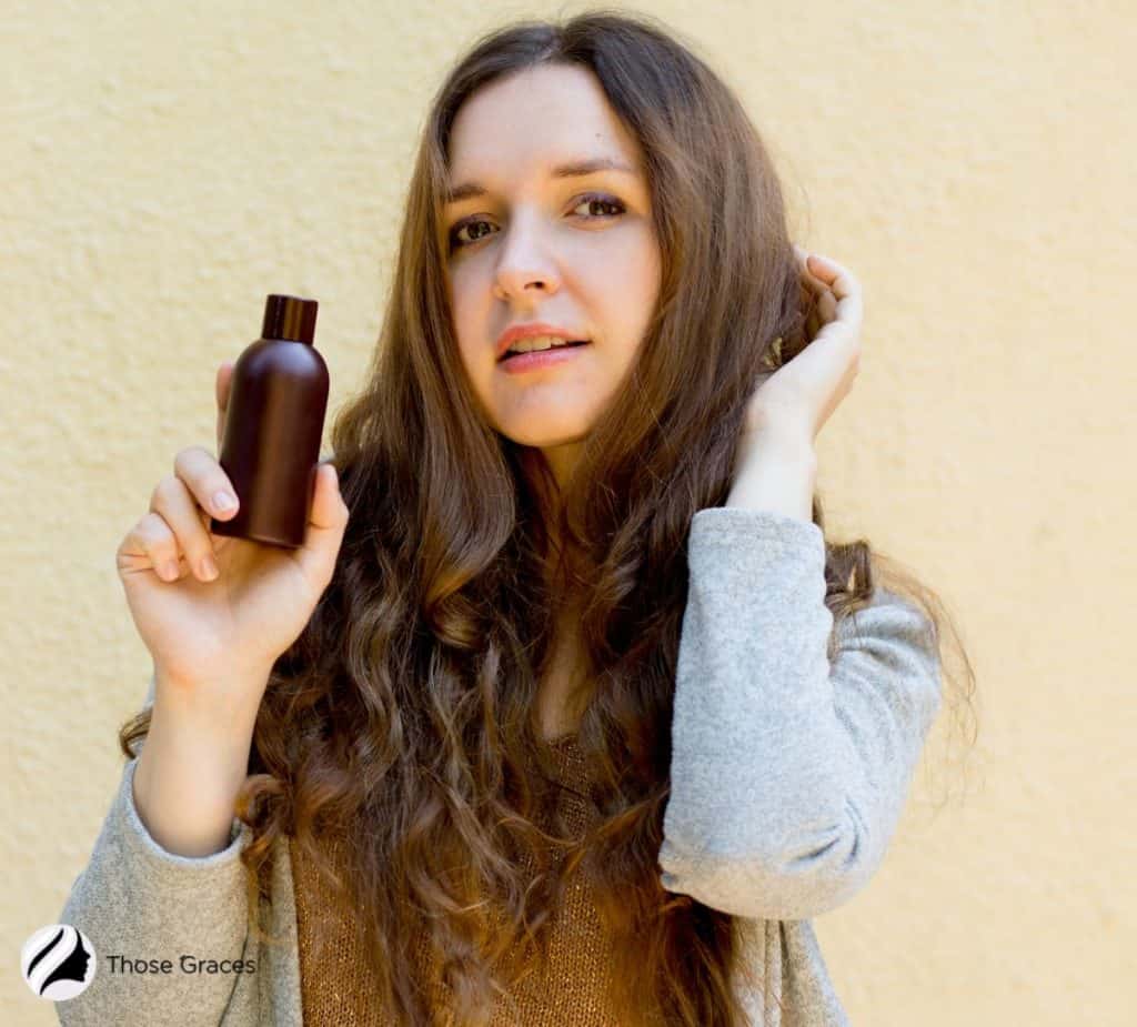 woman holding an argan oil shampoo