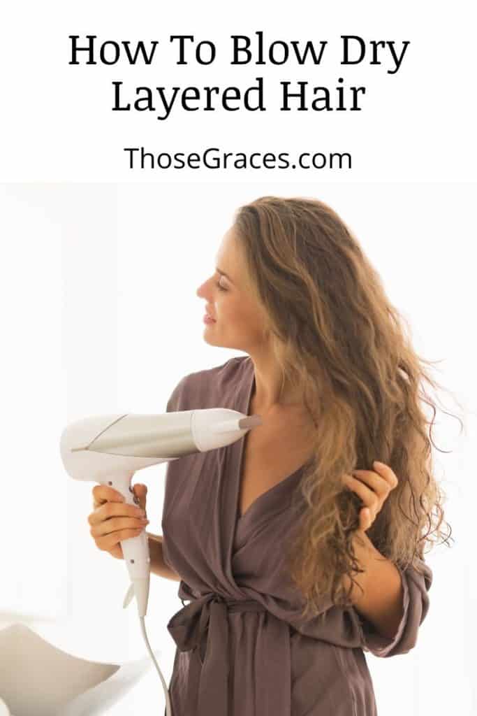 long-haired woman showing how to blow dry layered hair properly