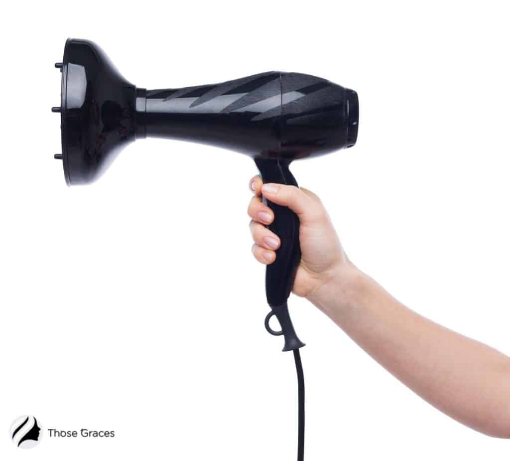 hand holding a hair dryer with diffuser