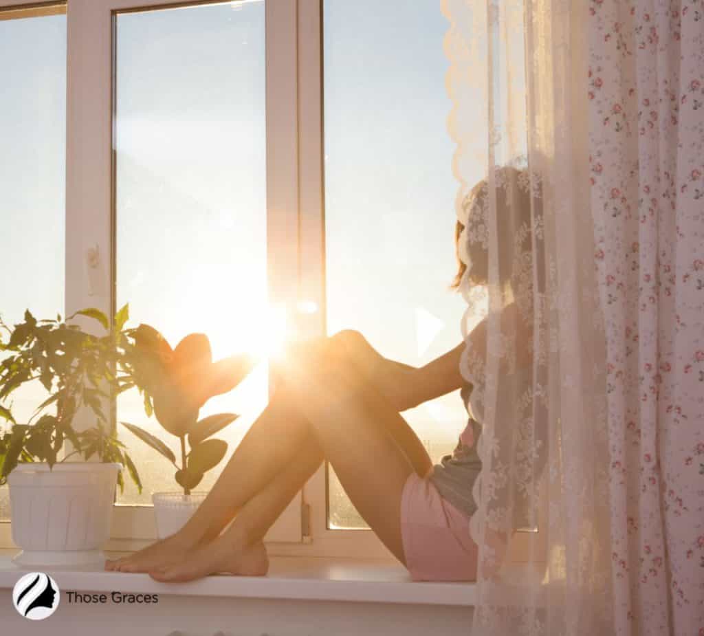 lady sitting beside the window with direct sunlight