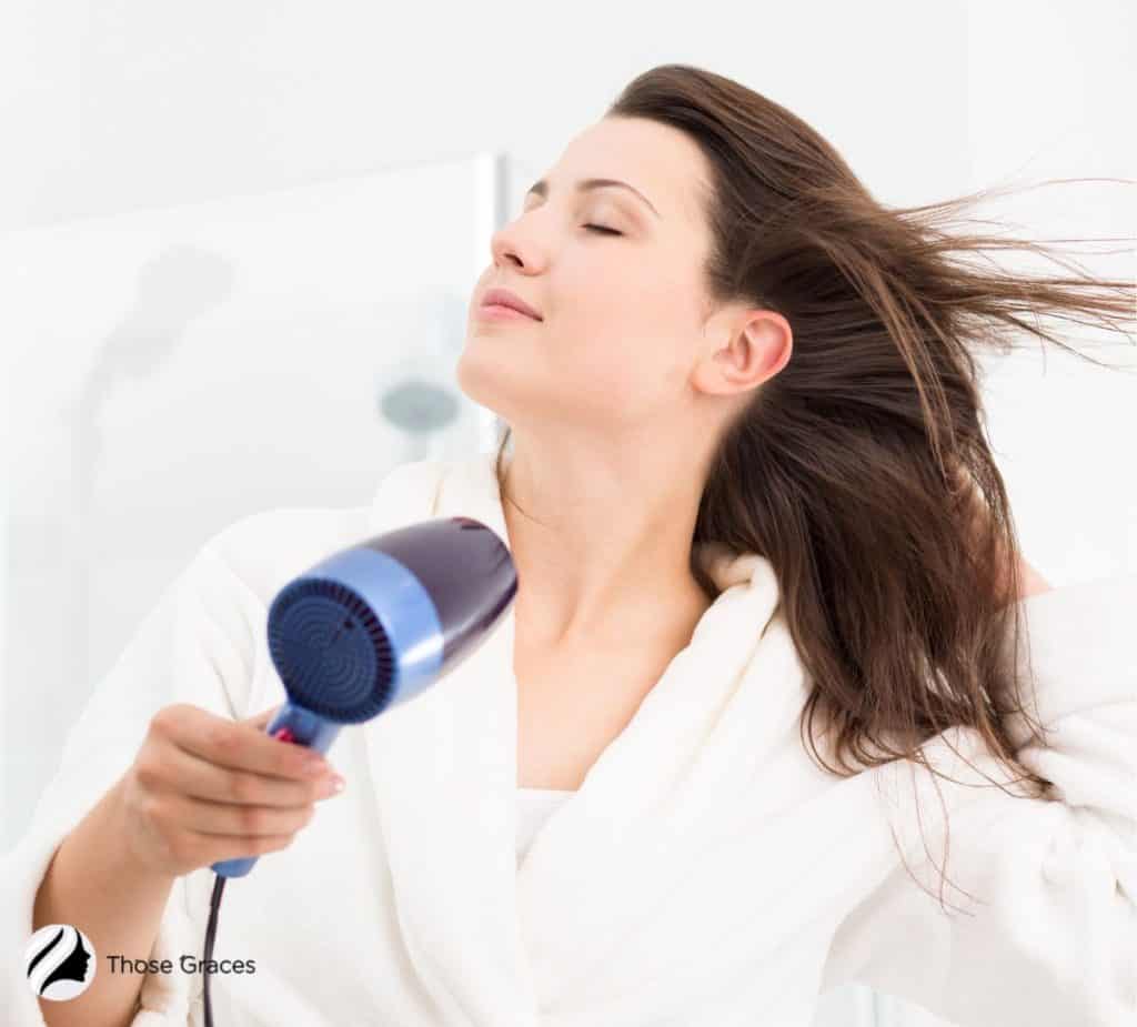 LADY USING A BLOW DRYER