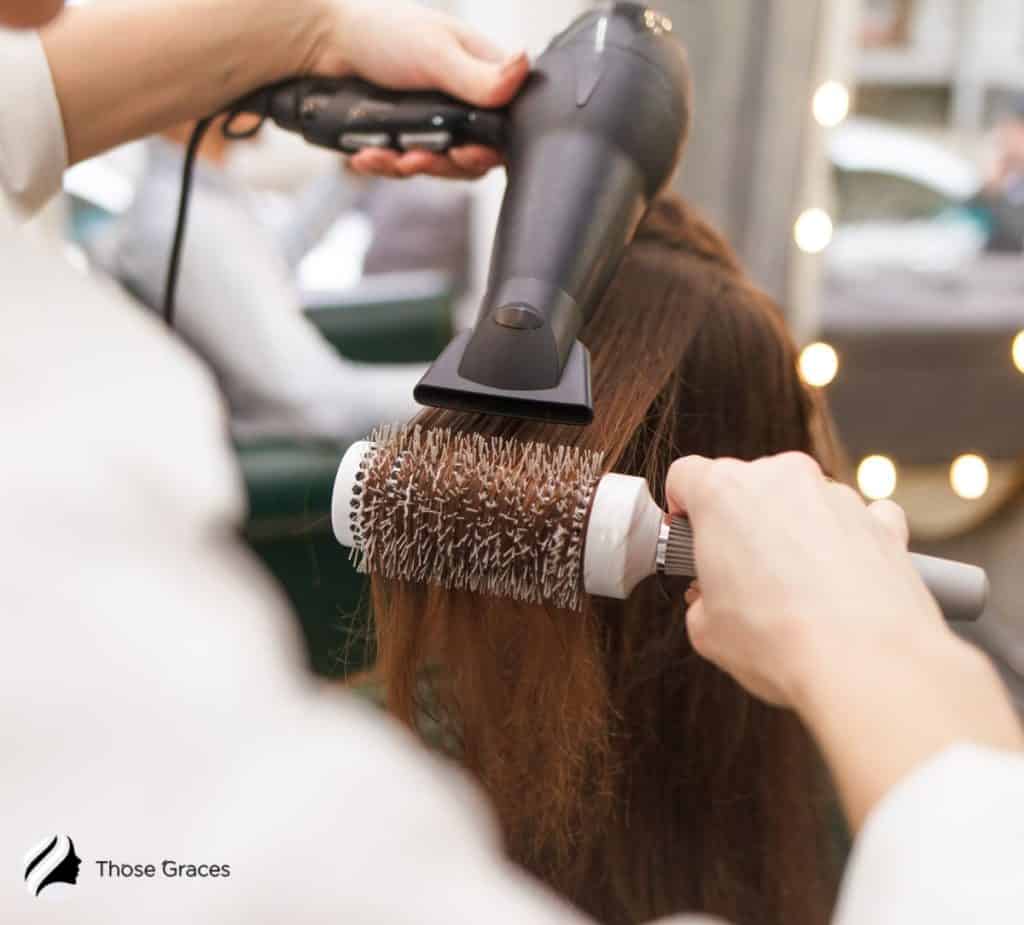 LADY USING A HAIR DRYER